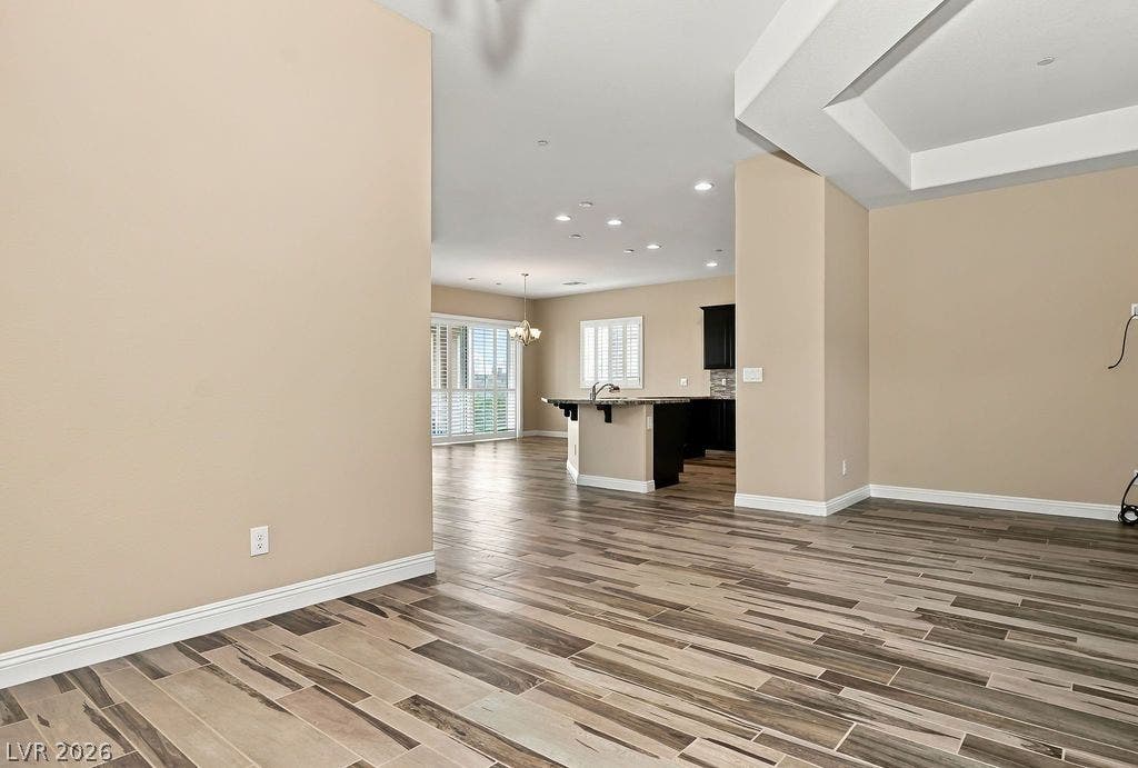 286 Lindura Court, Las Vegas, NV 89138 An open floorplan seamlessly connects the living space to the kitchen over modern plank flooring.