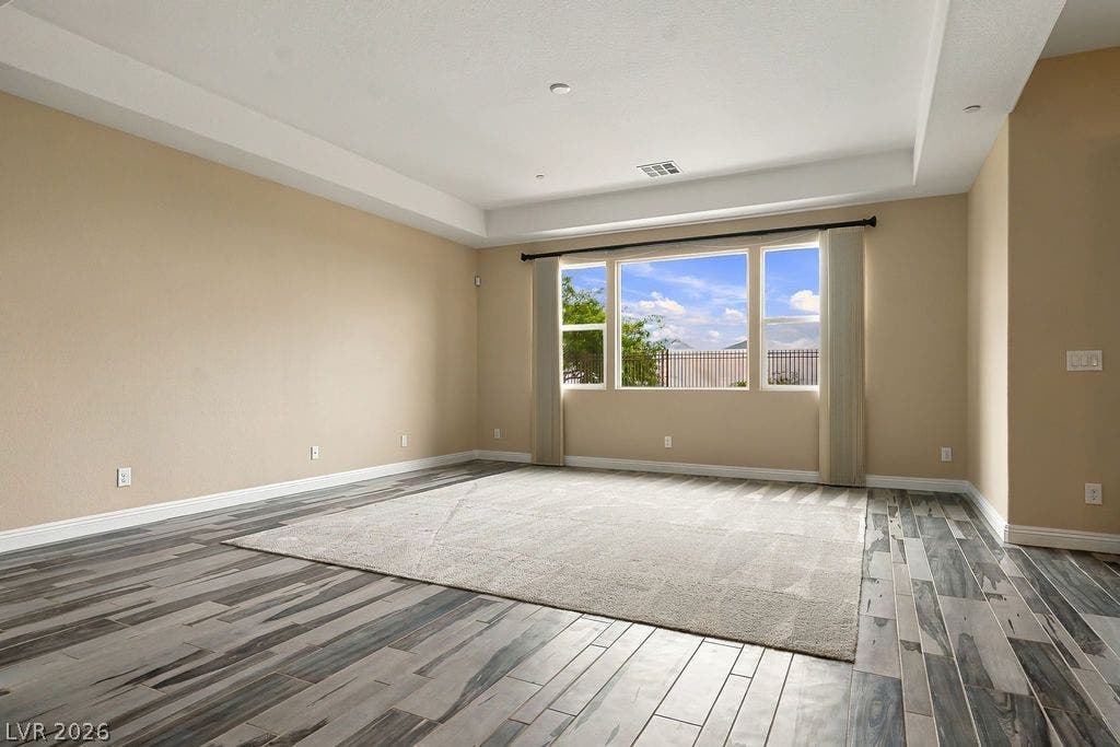 286 Lindura Court, Las Vegas, NV 89138 Distinctive tray ceilings and wood-look tile flooring create an elegant, open living space.