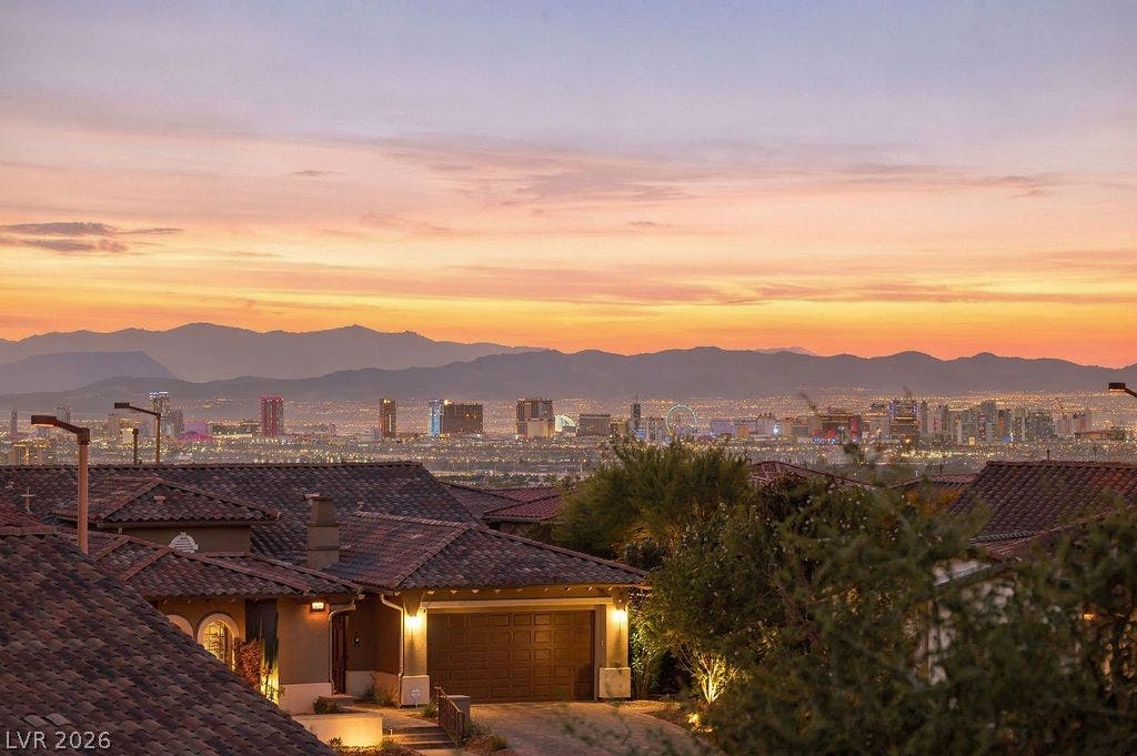 286 Lindura Court, Las Vegas, NV 89138 City lights and mountain ridges frame this spectacular elevated skyline outlook.