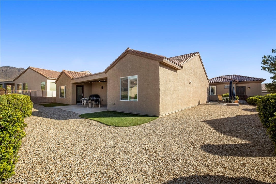 2432 Anderson Park Drive, Henderson, NV 89044 Low-maintenance desert landscaping surrounds a stucco exterior with a tiled roof and covered patio.