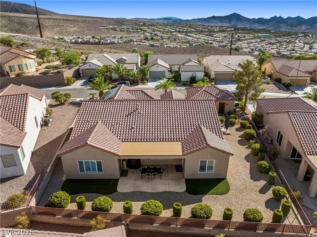 2432 Anderson Park Drive, Henderson, NV 89044 Tiled roofs and desert landscaping define this residential property set against a mountain backdrop.