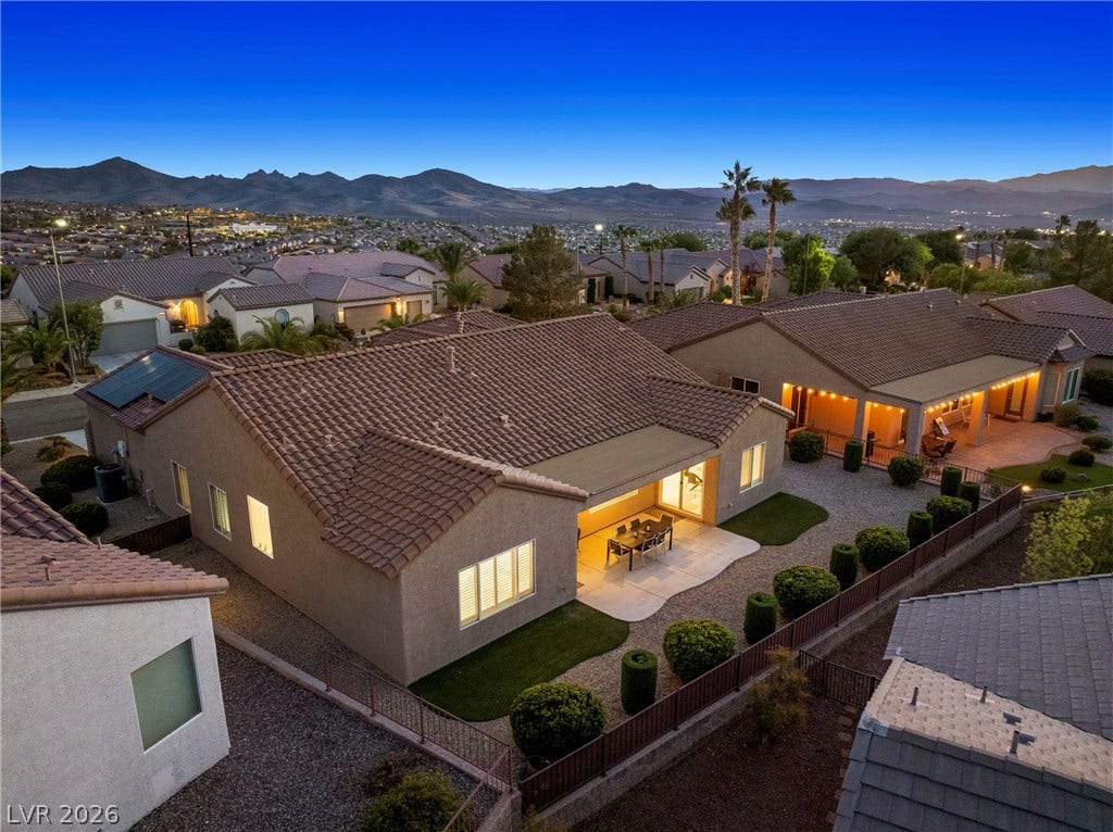 2432 Anderson Park Drive, Henderson, NV 89044 Terraced desert living features an inviting covered patio overlooking a panoramic mountain backdrop.
