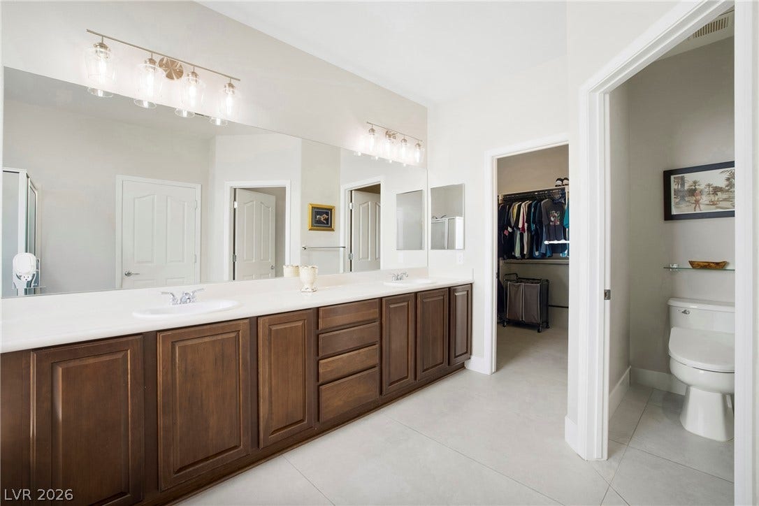 2432 Anderson Park Drive, Henderson, NV 89044 A spacious vanity with dual sinks leads directly into a large walk-in closet.