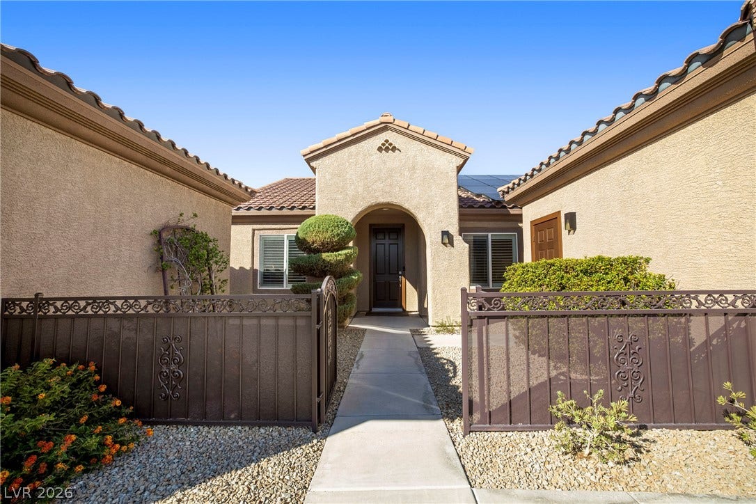 2432 Anderson Park Drive, Henderson, NV 89044 An inviting gated entry courtyard features a concrete walkway leading to the main entrance.