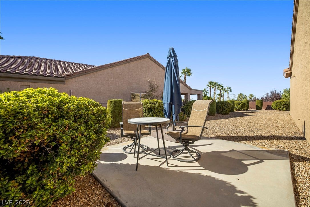 2432 Anderson Park Drive, Henderson, NV 89044 An inviting concrete patio provides a quiet outdoor retreat surrounded by low-maintenance desert landscaping.