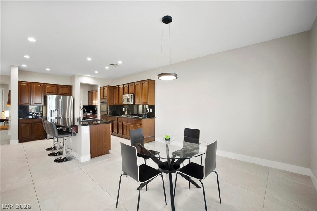 2432 Anderson Park Drive, Henderson, NV 89044 Gleaming tile floors stretch from the casual dining area into the open kitchen.