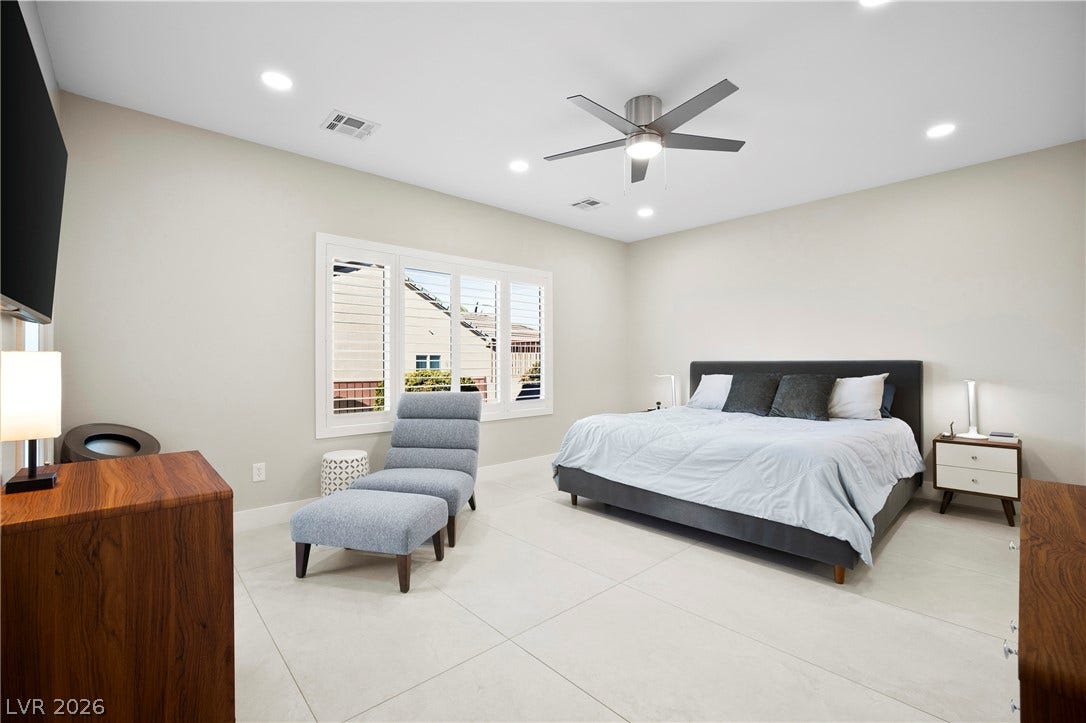 2432 Anderson Park Drive, Henderson, NV 89044 Recessed lighting and oversized tile flooring highlight this spacious, modern bedroom retreat.