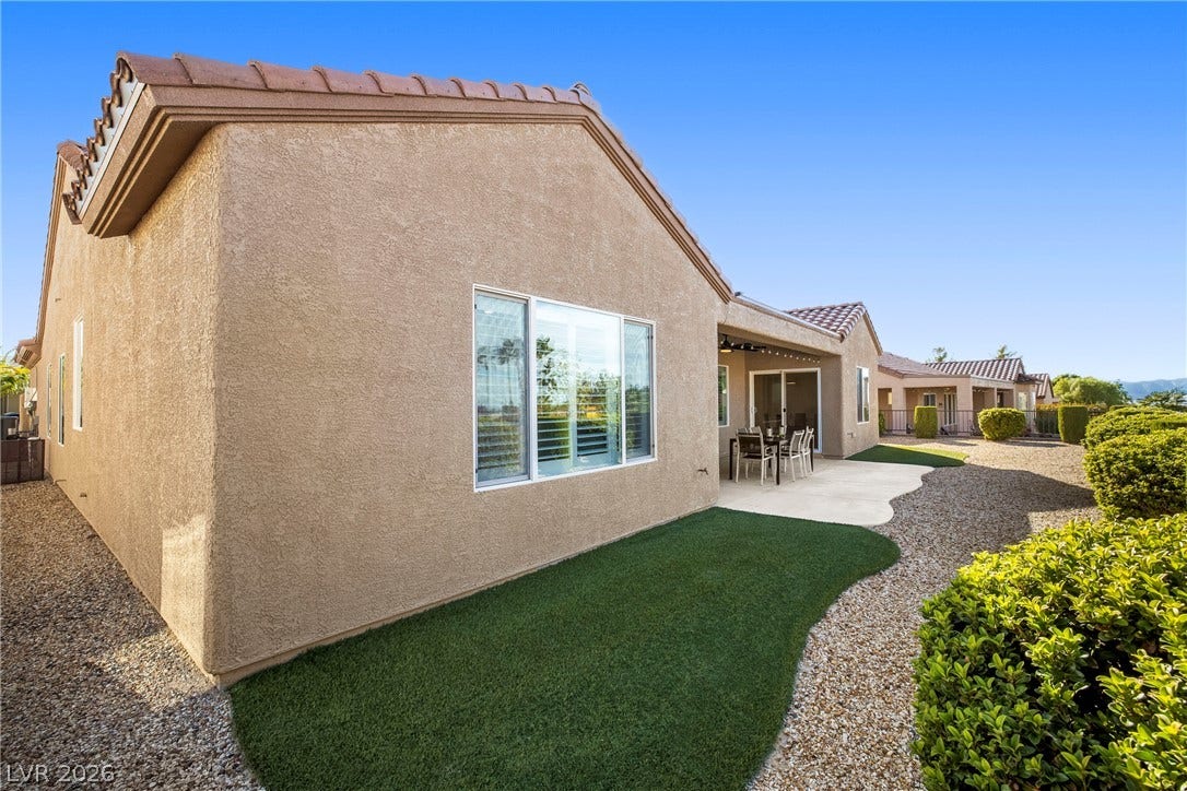 2432 Anderson Park Drive, Henderson, NV 89044 Low-maintenance desert landscaping surrounds a stucco exterior with tiled roofing and a rear patio area.
