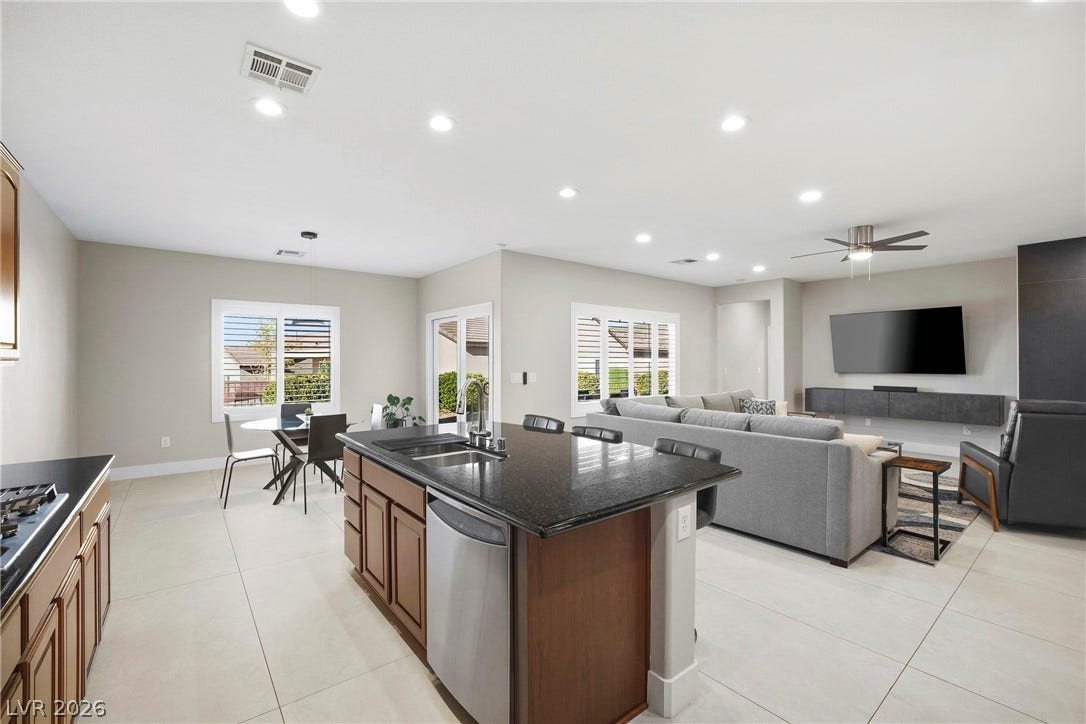 2432 Anderson Park Drive, Henderson, NV 89044 An open floorplan seamlessly connects the kitchen and living areas over polished tile flooring.
