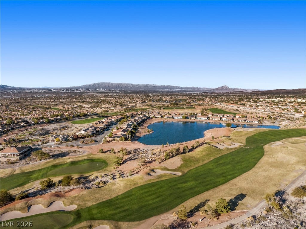2432 Anderson Park Drive, Henderson, NV 89044 A sweeping panorama captures the verdant golf course fairways bordered by a tranquil blue lake.