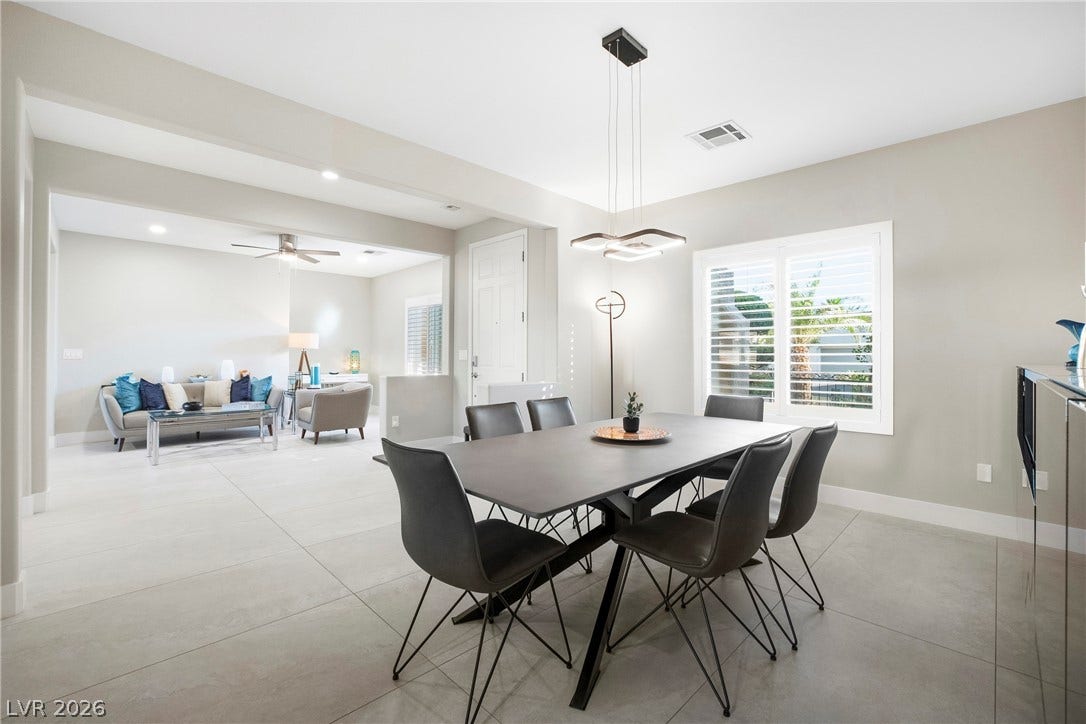 2432 Anderson Park Drive, Henderson, NV 89044 Gleaming tile floors and natural light from plantation shutters define this open-plan dining space.