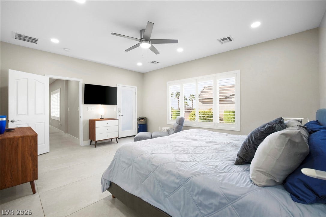 2432 Anderson Park Drive, Henderson, NV 89044 Smooth tiled floors and recessed lighting enhance this serene bedroom retreat.