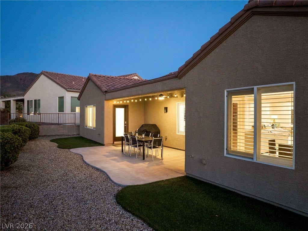 2432 Anderson Park Drive, Henderson, NV 89044 A covered patio expands the outdoor living area alongside a low-maintenance gravel yard.