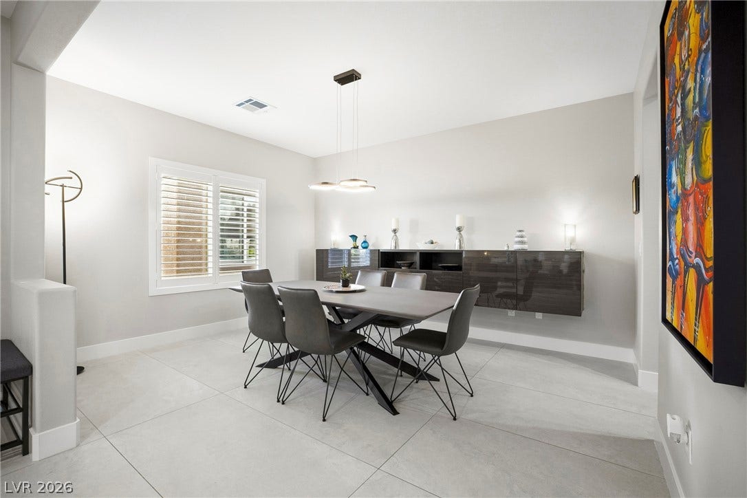 2432 Anderson Park Drive, Henderson, NV 89044 Large tile flooring and crisp crown molding highlight this modern dining room.