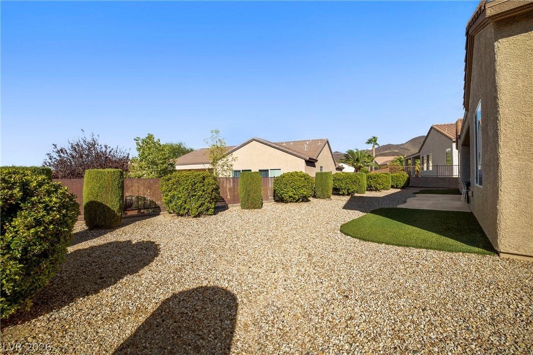 2432 Anderson Park Drive, Henderson, NV 89044 Low-maintenance desert landscaping and manicured hedges define this tidy backyard retreat.