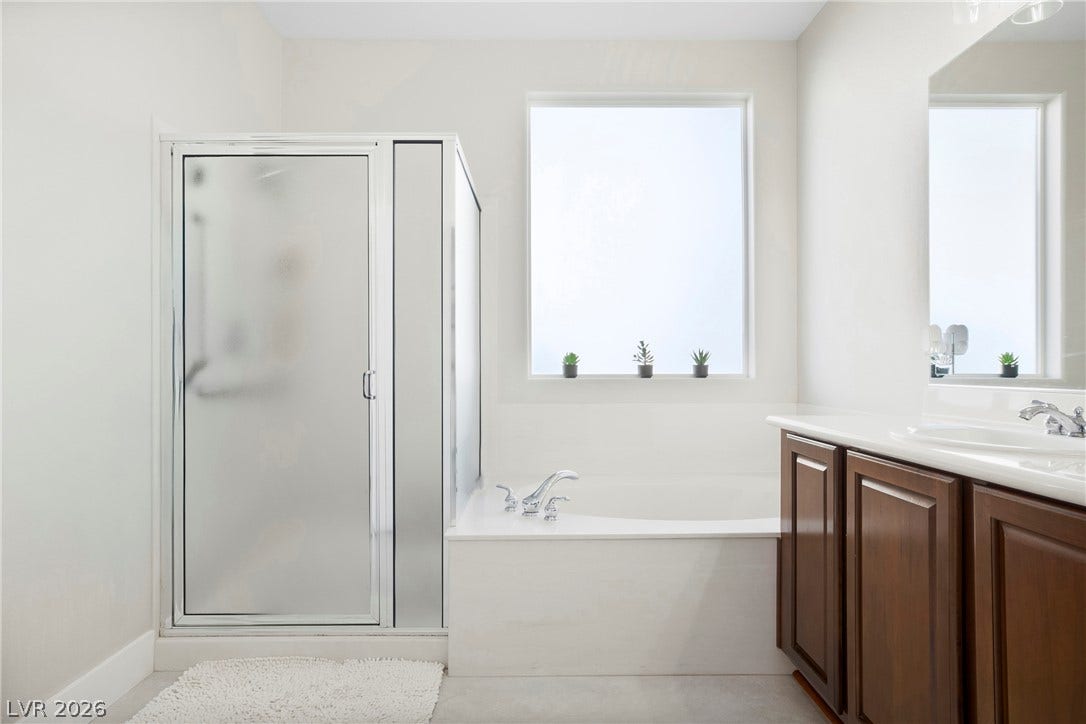 2432 Anderson Park Drive, Henderson, NV 89044 Natural light pours over the soaking tub and separate shower enclosure in this bathroom.