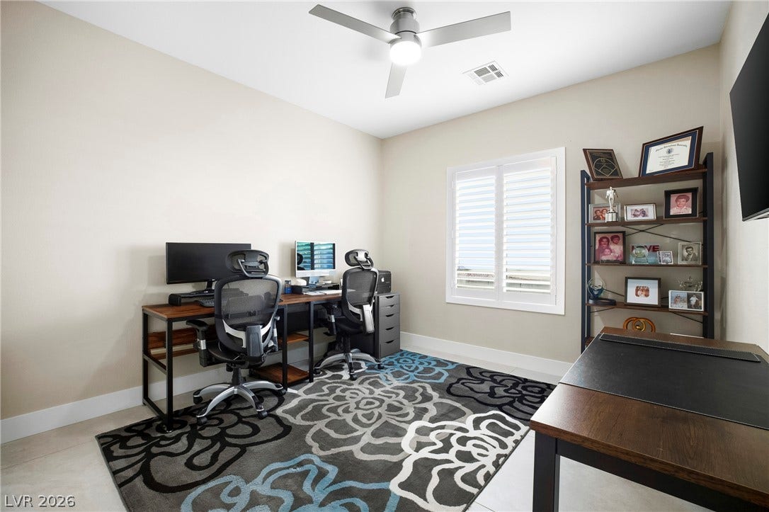 2432 Anderson Park Drive, Henderson, NV 89044 Smooth tile flooring, clean-lined walls, and a plantation-shuttered window highlight this versatile workspace.