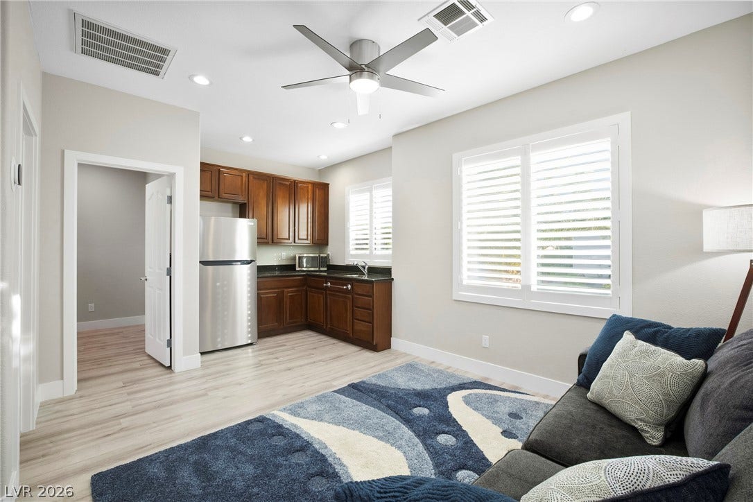 2432 Anderson Park Drive, Henderson, NV 89044 An open living space connects to a convenient corner kitchenette with wood cabinetry.