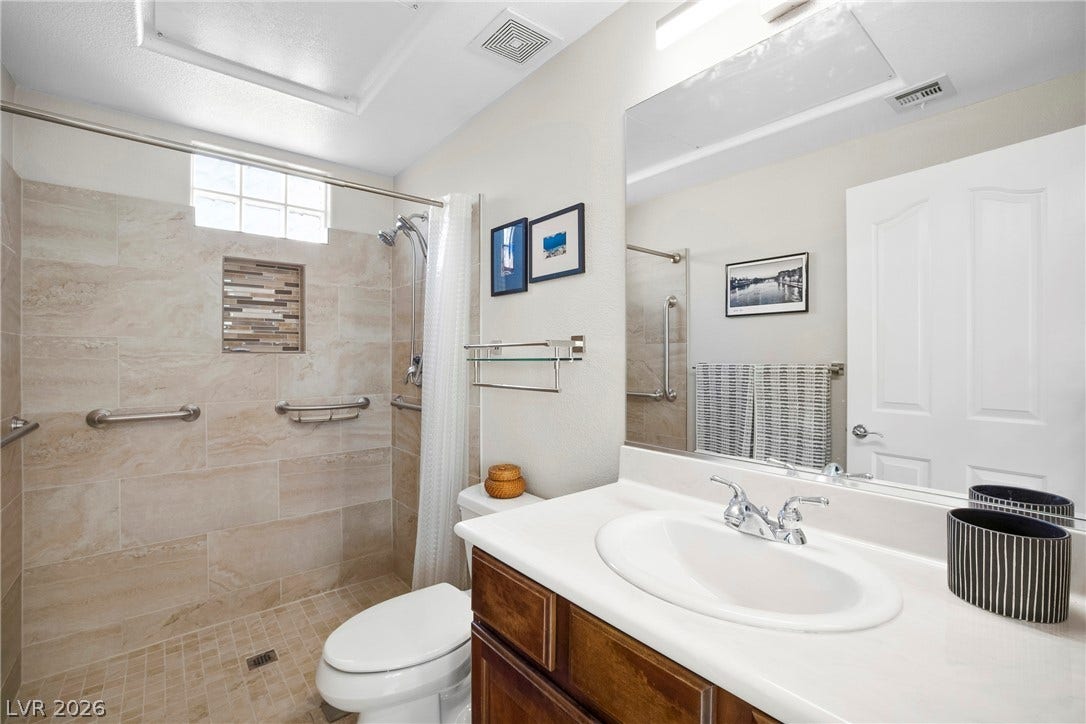 2432 Anderson Park Drive, Henderson, NV 89044 A classic vanity and tiled walk-in shower compose this functional, well-appointed bathroom.