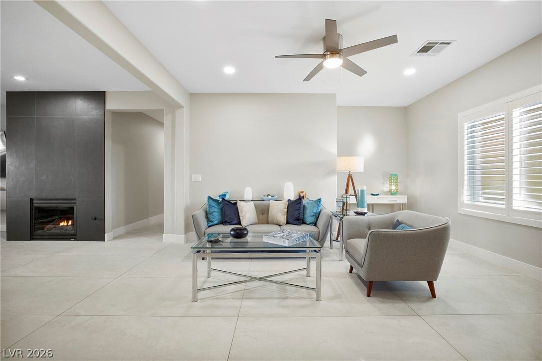 2432 Anderson Park Drive, Henderson, NV 89044 A modern fireplace and large format tile flooring anchors this open living space.