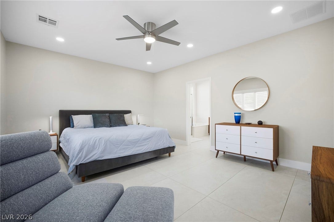 2432 Anderson Park Drive, Henderson, NV 89044 Smooth tile flooring and clean lines define this modern suite leading to an attached bath.