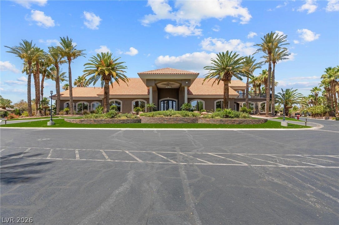 8175 Arville Street, #203, Las Vegas, NV 89139 Stately palm trees frame the grand tiled-roof entrance of this elegant Mediterranean-style estate.