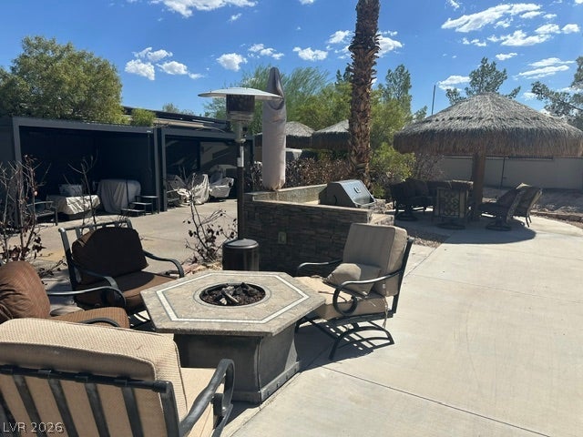 8175 Arville Street, #203, Las Vegas, NV 89139 An inviting stone fire pit and built-in barbecue station define this concrete patio area.