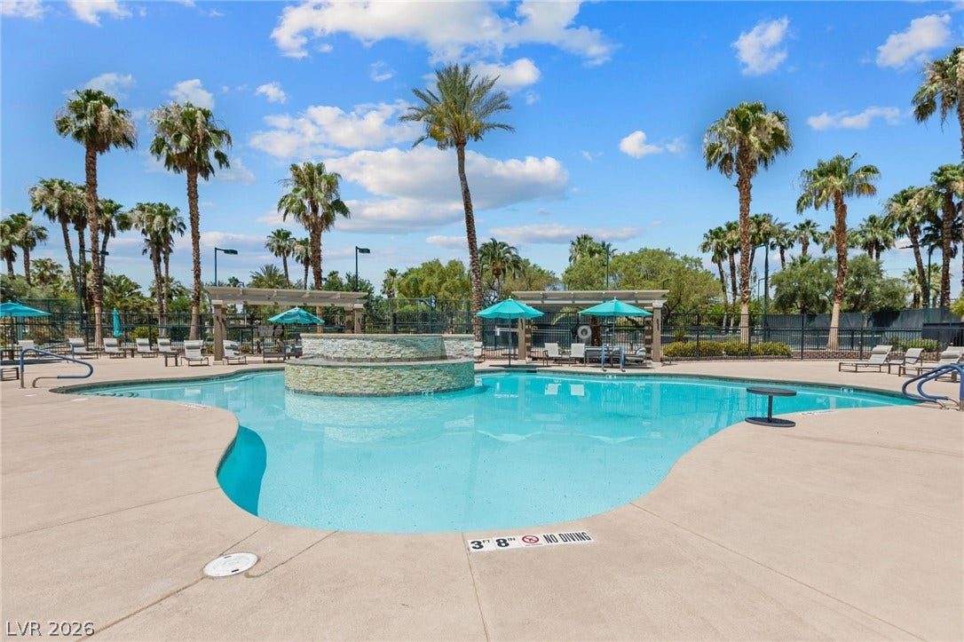 8175 Arville Street, #203, Las Vegas, NV 89139 Soak in the sun beside a sparkling swimming pool framed by towering palm trees.