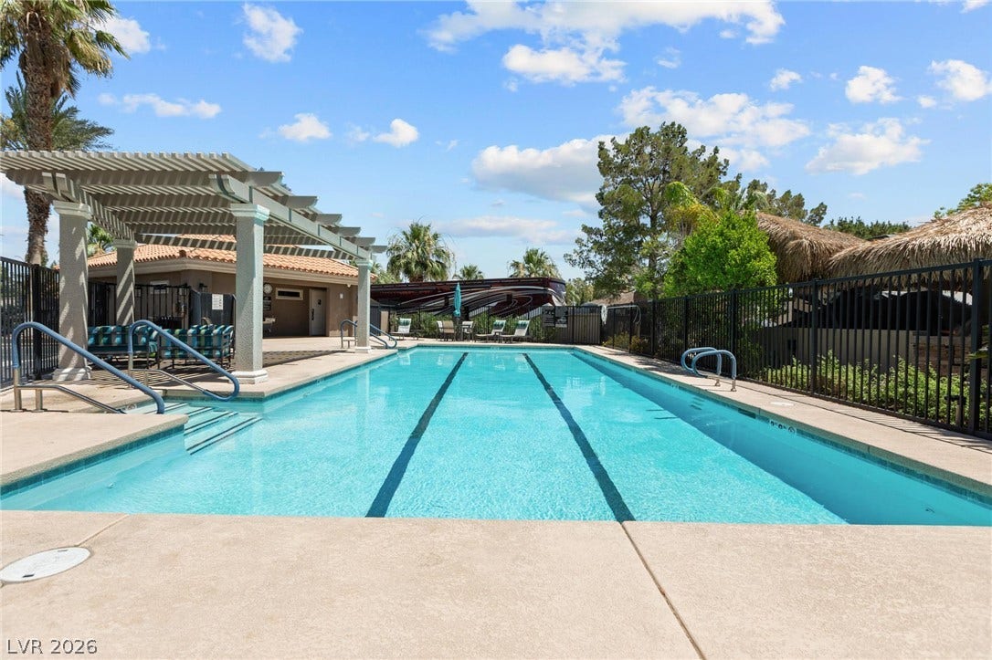 8175 Arville Street, #203, Las Vegas, NV 89139 An inviting swimming pool features designated lap lanes and a poolside pergola.