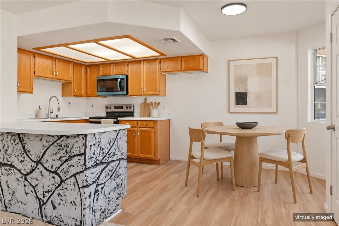 Warm wood cabinetry and durable hard-surface flooring anchor this functional culinary layout.