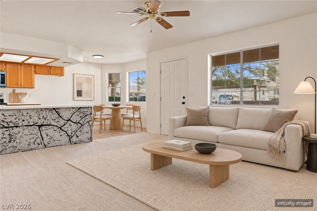 An open living room transitions smoothly into the dining area and kitchen.