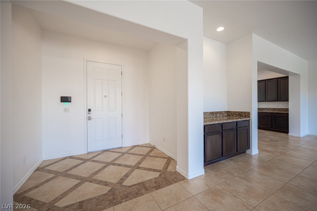 8618 Amber Autumn Street, Las Vegas, NV 89131 An inviting entryway transitions smoothly into the open-concept living space with patterned tile flooring.