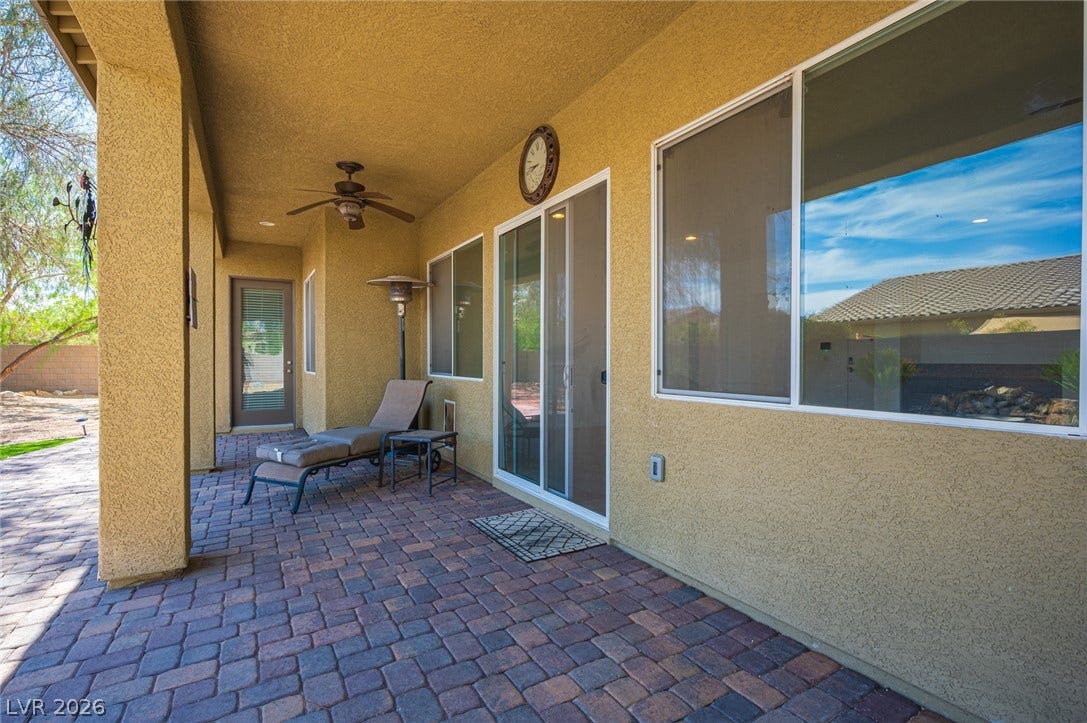8618 Amber Autumn Street, Las Vegas, NV 89131 Shaded brick pavers line this comfortable outdoor living area ideal for relaxing.