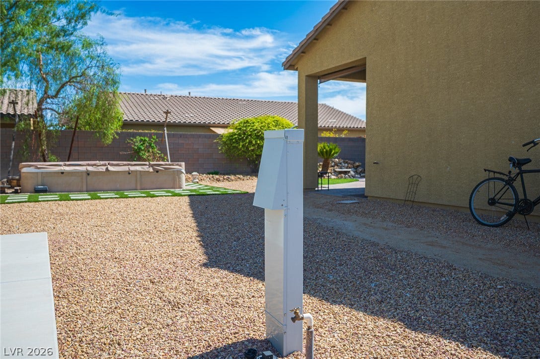 8618 Amber Autumn Street, Las Vegas, NV 89131 A low-maintenance gravel yard adjoins the main structure under clear desert skies.