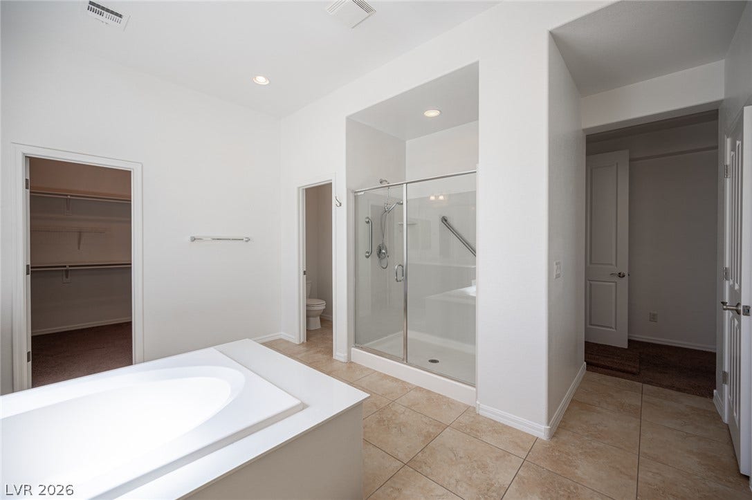 8618 Amber Autumn Street, Las Vegas, NV 89131 A spacious layout showcases a separate soaking tub and a walk-in glass shower.