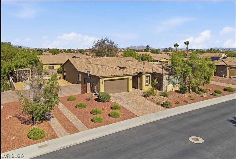 8618 Amber Autumn Street, Las Vegas, NV 89131 Meticulously manicured desert landscaping frames this classic single-story residence with a tile roof.