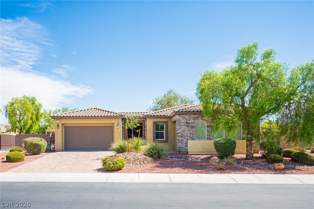 8618 Amber Autumn Street, Las Vegas, NV 89131 Stone accents and desert landscaping enhance the curb appeal of this single-story residence.