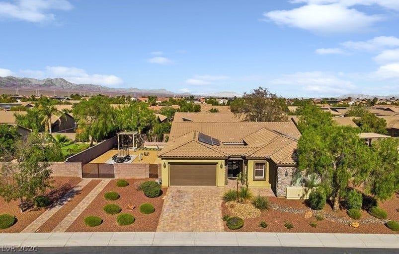 8618 Amber Autumn Street, Las Vegas, NV 89131 An attractive tile roof and a paved driveway enhance this desert-landscaped home.