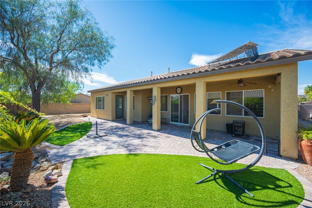 8618 Amber Autumn Street, Las Vegas, NV 89131 An inviting covered patio opens to a beautifully paved terrace and manicured lawn areas.