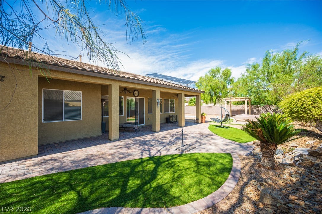 8618 Amber Autumn Street, Las Vegas, NV 89131 An inviting covered patio overlooks the neatly landscaped backyard with desert-inspired plantings.