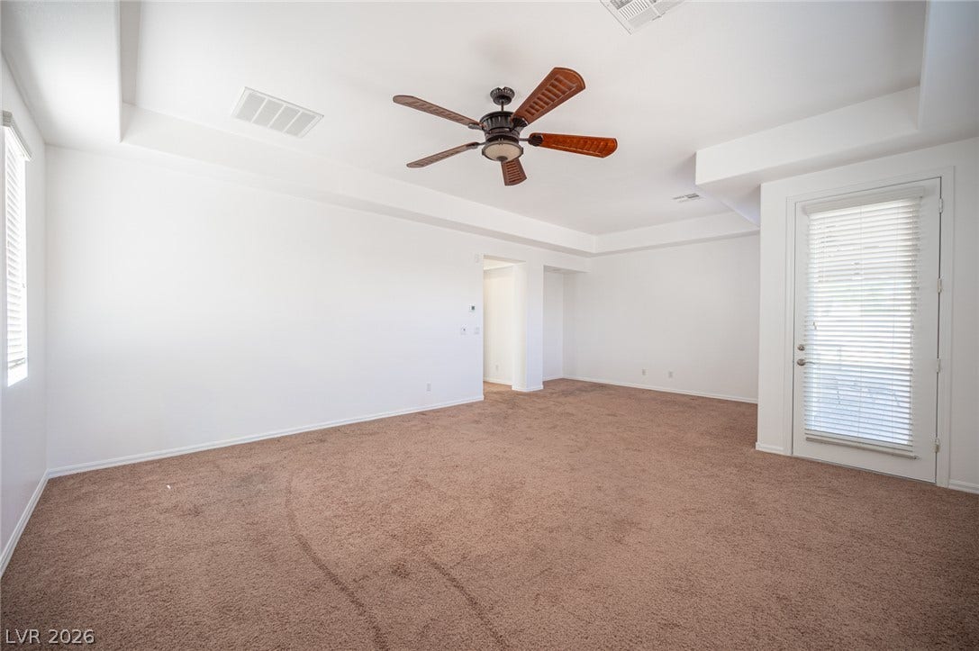 8618 Amber Autumn Street, Las Vegas, NV 89131 A spacious carpeted living area features clean walls and a recessed ceiling design.