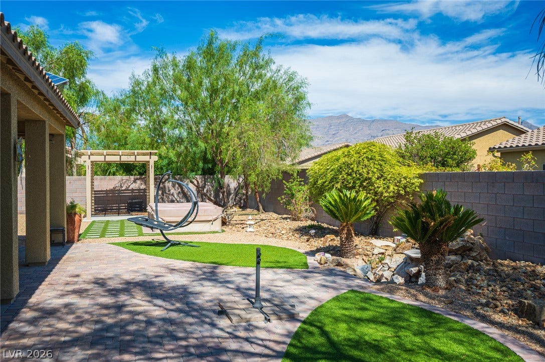8618 Amber Autumn Street, Las Vegas, NV 89131 An inviting backyard oasis features stone pavers and scenic mountain views.