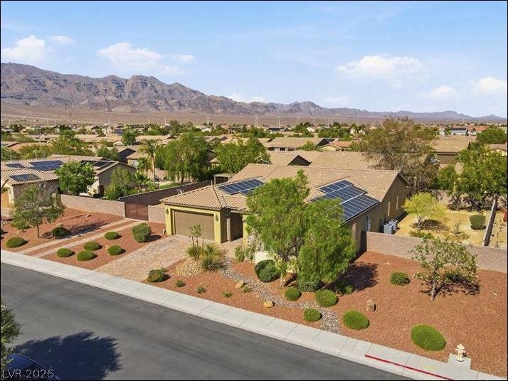 8618 Amber Autumn Street, Las Vegas, NV 89131 Desert landscaping and solar panels complement this modern home set against a mountain backdrop.