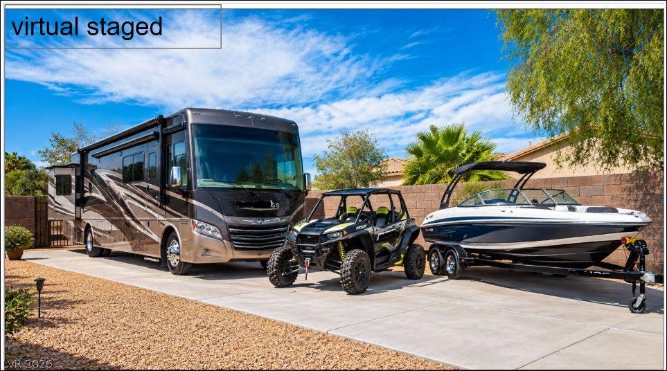 8618 Amber Autumn Street, Las Vegas, NV 89131 A spacious concrete driveway provides ample room for recreational vehicles and outdoor storage.