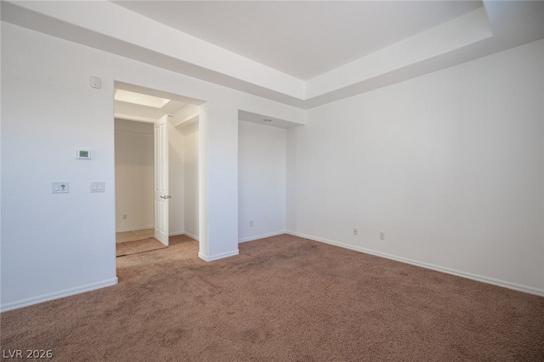 8618 Amber Autumn Street, Las Vegas, NV 89131 An elegant tray ceiling and soft wall-to-wall carpeting define this versatile living space.