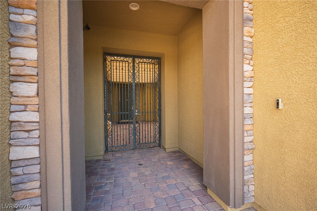 8618 Amber Autumn Street, Las Vegas, NV 89131 An inviting gated courtyard entry features warm stucco finishes and elegant stone accents.