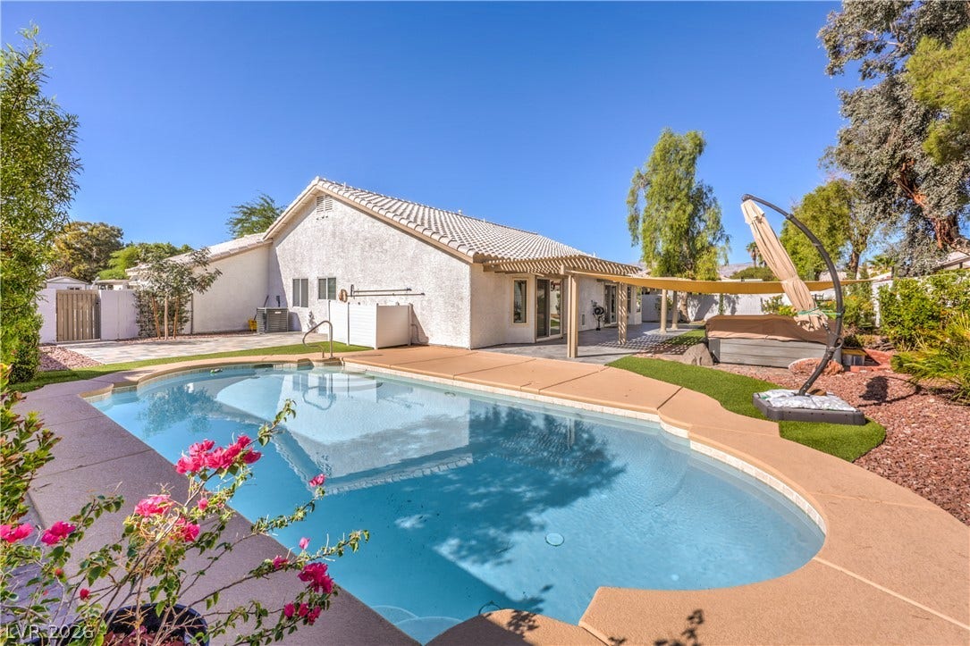 7504 Powder River Court, Las Vegas, NV 89131 A pristine swimming pool anchors the backyard retreat under clear desert skies.
