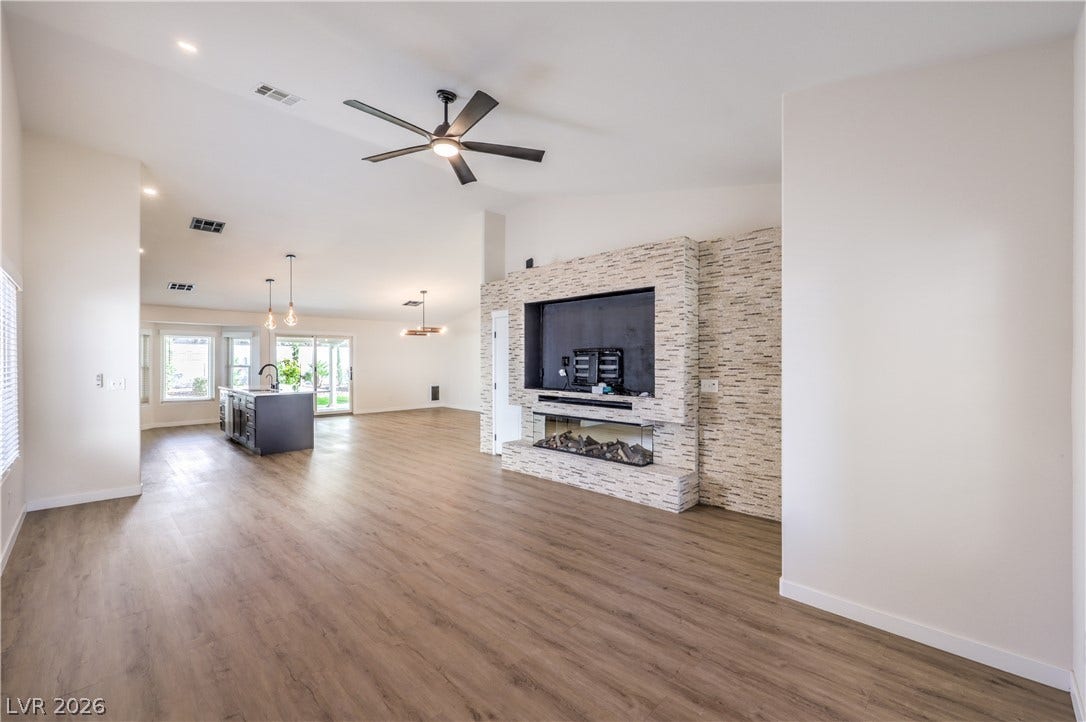 7504 Powder River Court, Las Vegas, NV 89131 An open floorplan connects the living area to the kitchen over durable wood-look flooring.