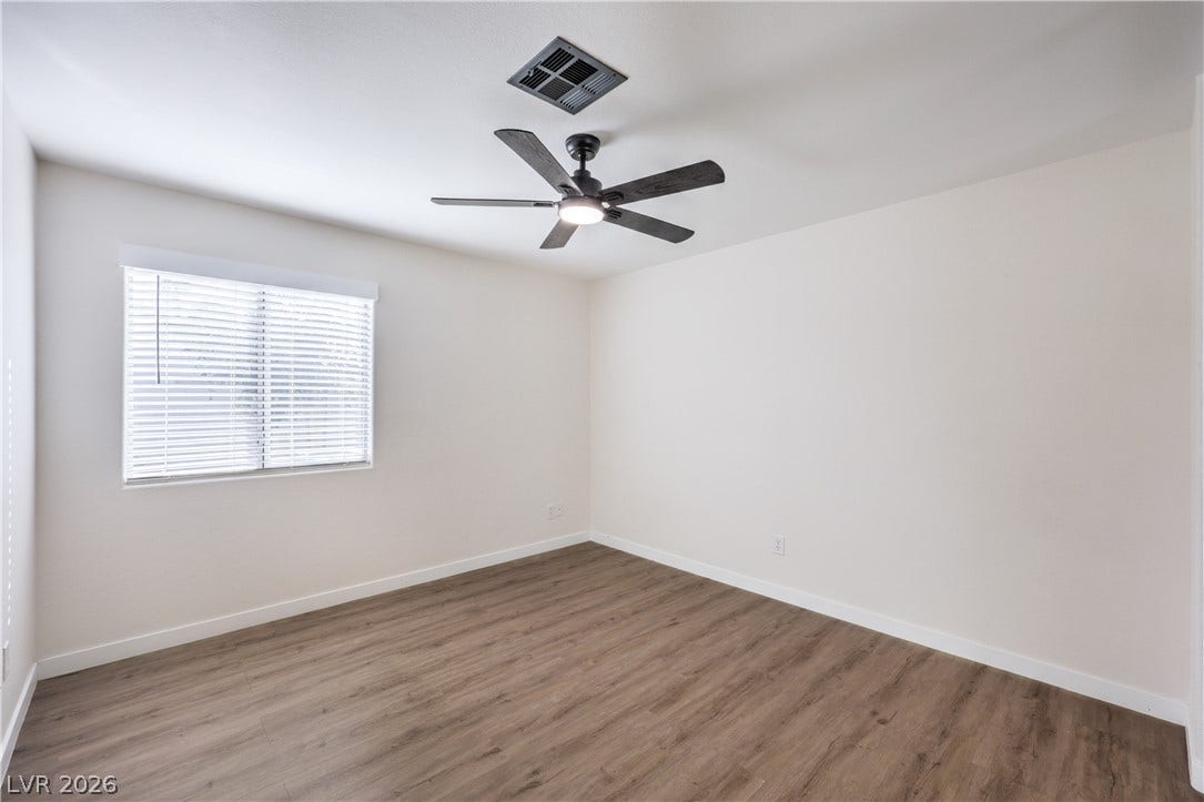 7504 Powder River Court, Las Vegas, NV 89131 Crisp white walls and clean-lined wood flooring set a serene tone.