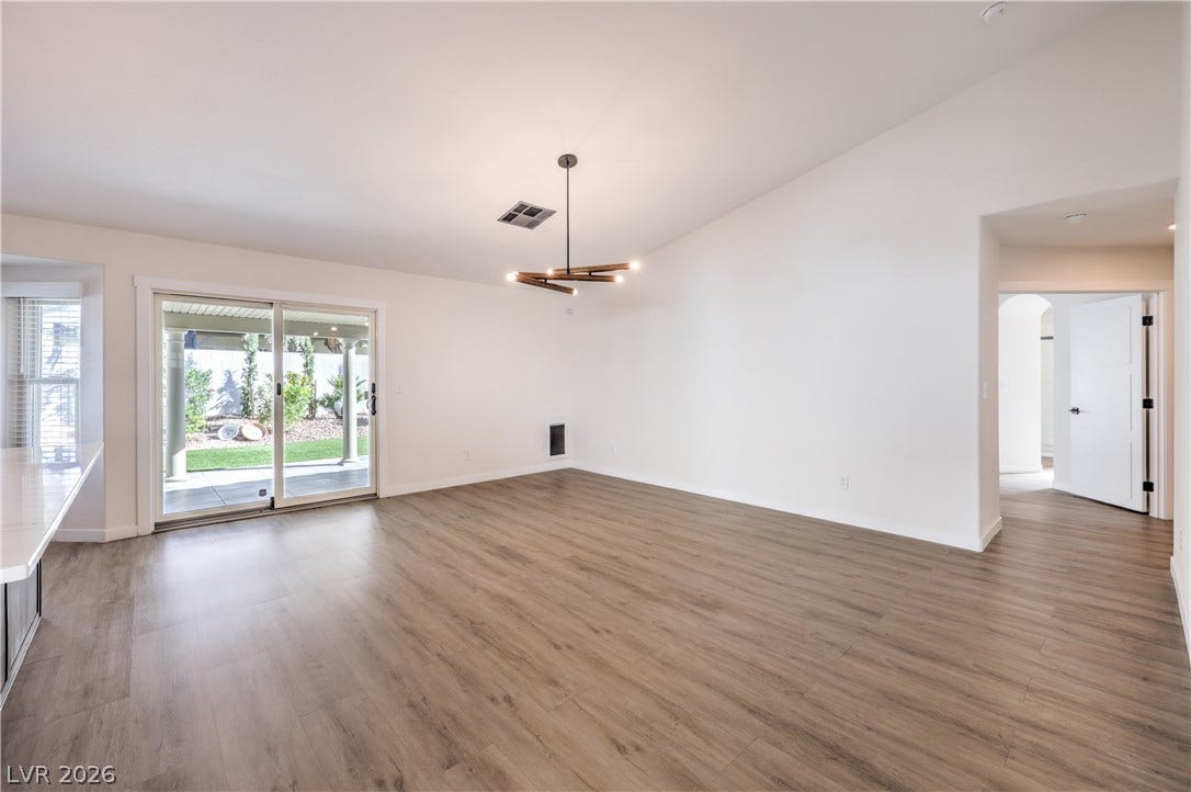 7504 Powder River Court, Las Vegas, NV 89131 Sliding glass doors open to the patio from this spacious living area with wood floors.